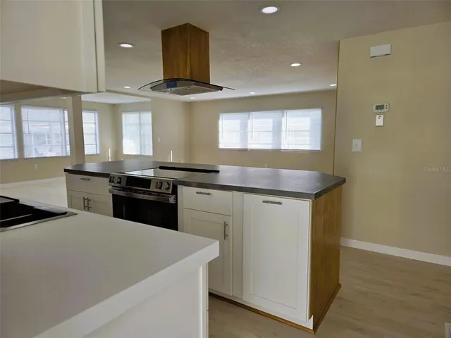 a kitchen with stainless steel appliances granite countertop a sink and a stove