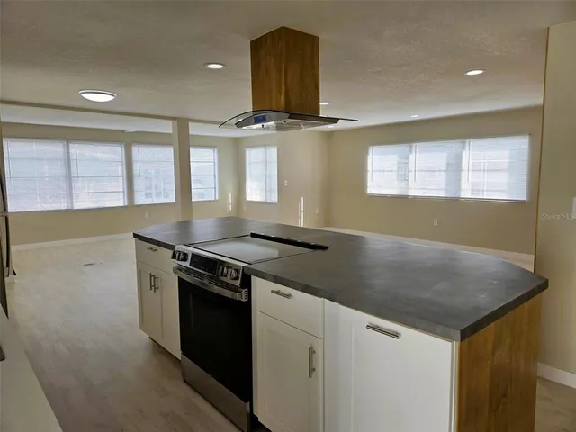 a kitchen with granite countertop a stove and a sink