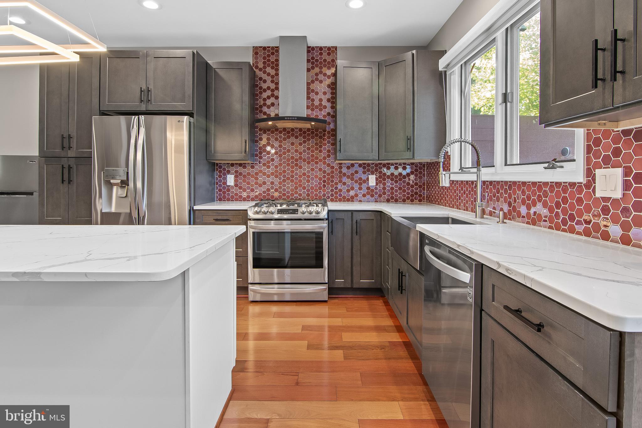 108 Lancefield Road Baltimore, MD 21209 - Photo 14 of 28 a kitchen with stainless steel appliances a sink stove and refrigerator