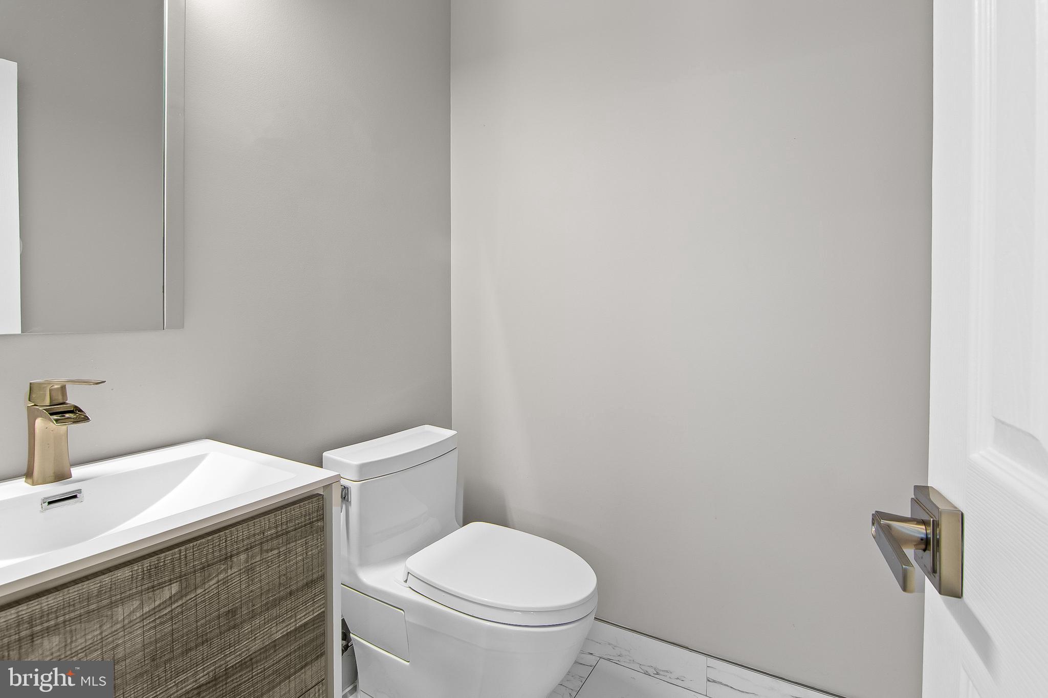 108 Lancefield Road Baltimore, MD 21209 - Photo 20 of 28 a white toilet sitting next to a bathroom sink