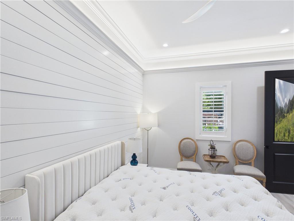 3650 Sunset Boulevard Naples, FL 34112 - Photo 12 of 26 Accent shiplap wall paired with crown molding and recessed lighting