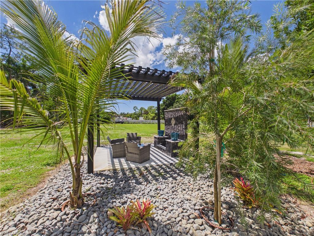 3650 Sunset Boulevard Naples, FL 34112 - Photo 24 of 26 Outdoor pergola structure with a slatted roof, featuring a concrete patio base