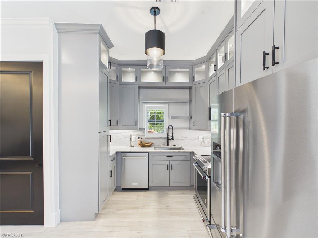 3650 Sunset Boulevard Naples, FL 34112 - Photo 10 of 26 Kitchen with light gray cabinetry, stainless steel appliances, white marble-look countertops, and recessed lighting