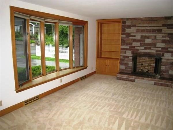 27 Hampden Road Framingham, MA 01702 - Photo 5 of 8 a view of an empty room with a fireplace and a window