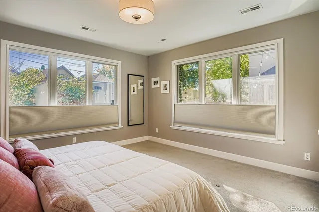 a bedroom with a large bed and a large window