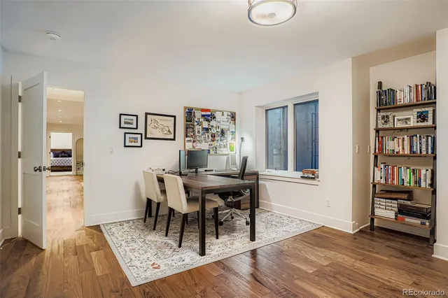 a view of a dining room with furniture and wooden floor