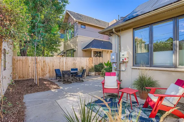 a backyard of a house with outdoor seating