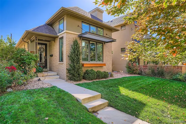 a front view of a house with a yard and porch