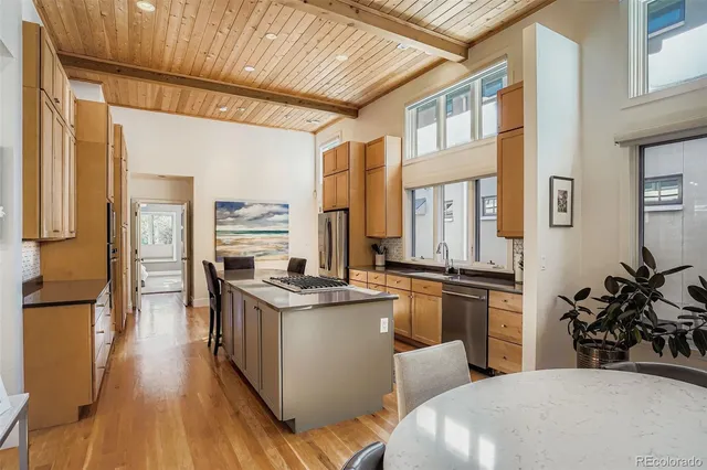 a kitchen with stainless steel appliances granite countertop a stove and a refrigerator