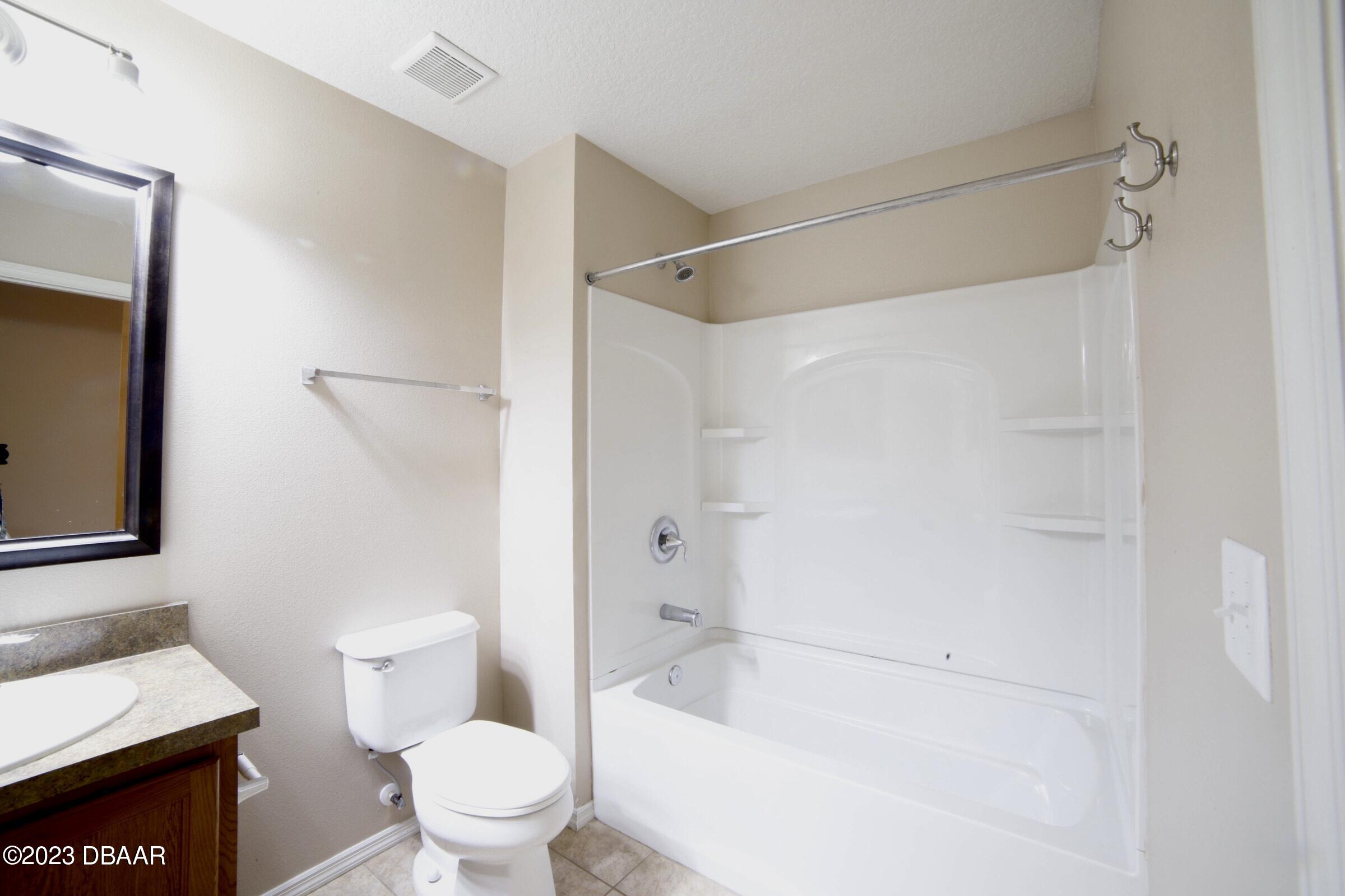 63 Levee Lane Ormond Beach, FL 32174 - Photo 12 of 41 a white toilet sitting next to a bath tub