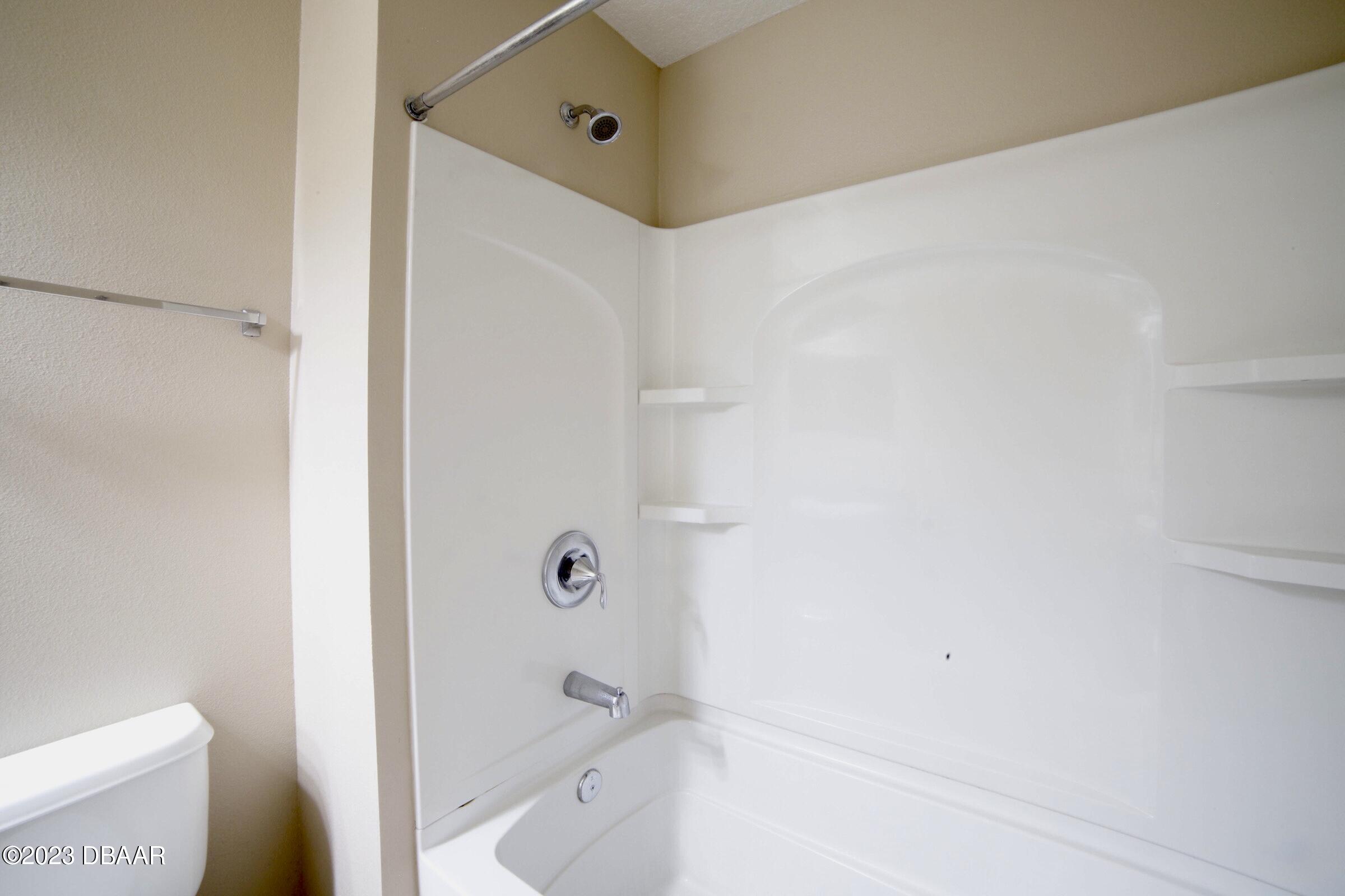 63 Levee Lane Ormond Beach, FL 32174 - Photo 14 of 41 a bathroom with a bathtub and a toilet