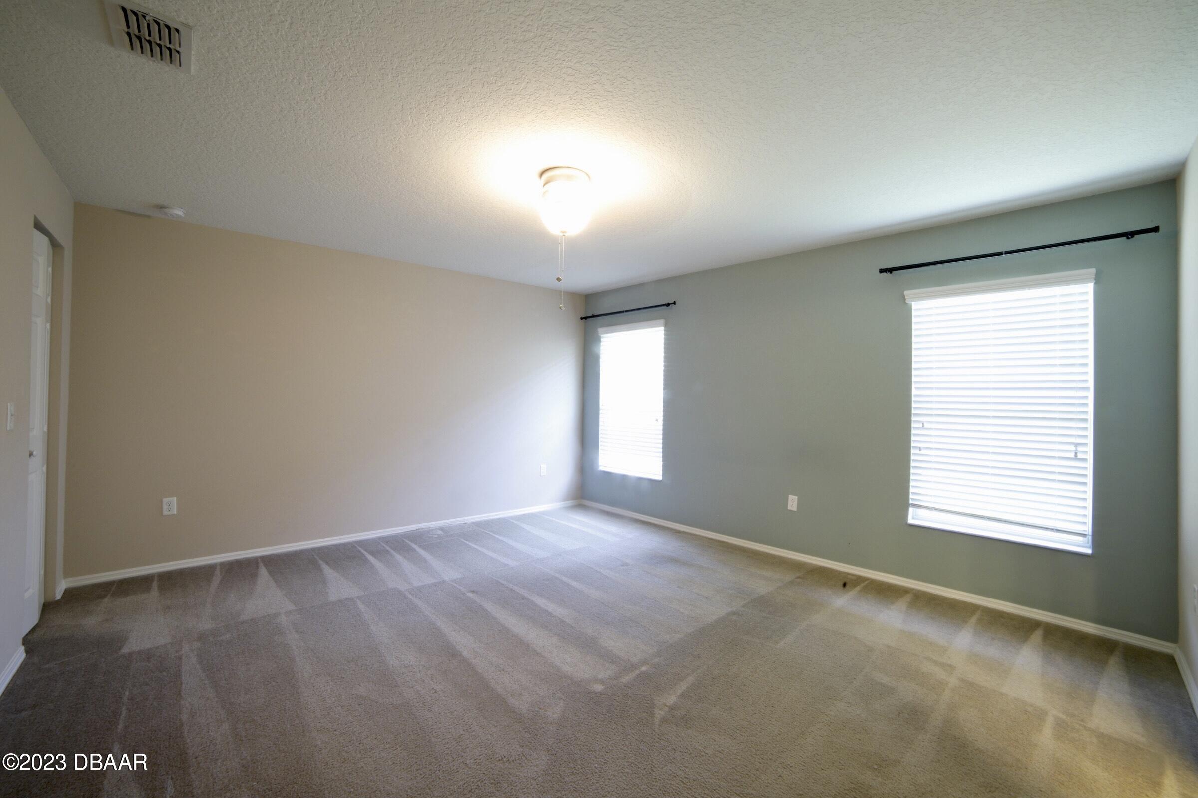 63 Levee Lane Ormond Beach, FL 32174 - Photo 19 of 41 an empty room with windows