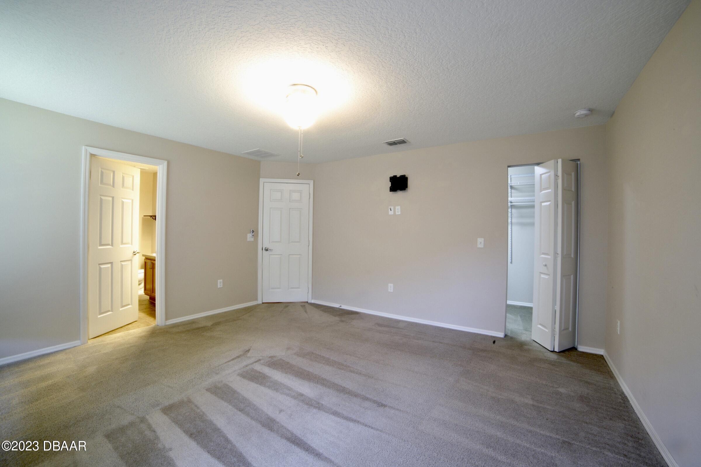 63 Levee Lane Ormond Beach, FL 32174 - Photo 20 of 41 an empty room with windows and closet