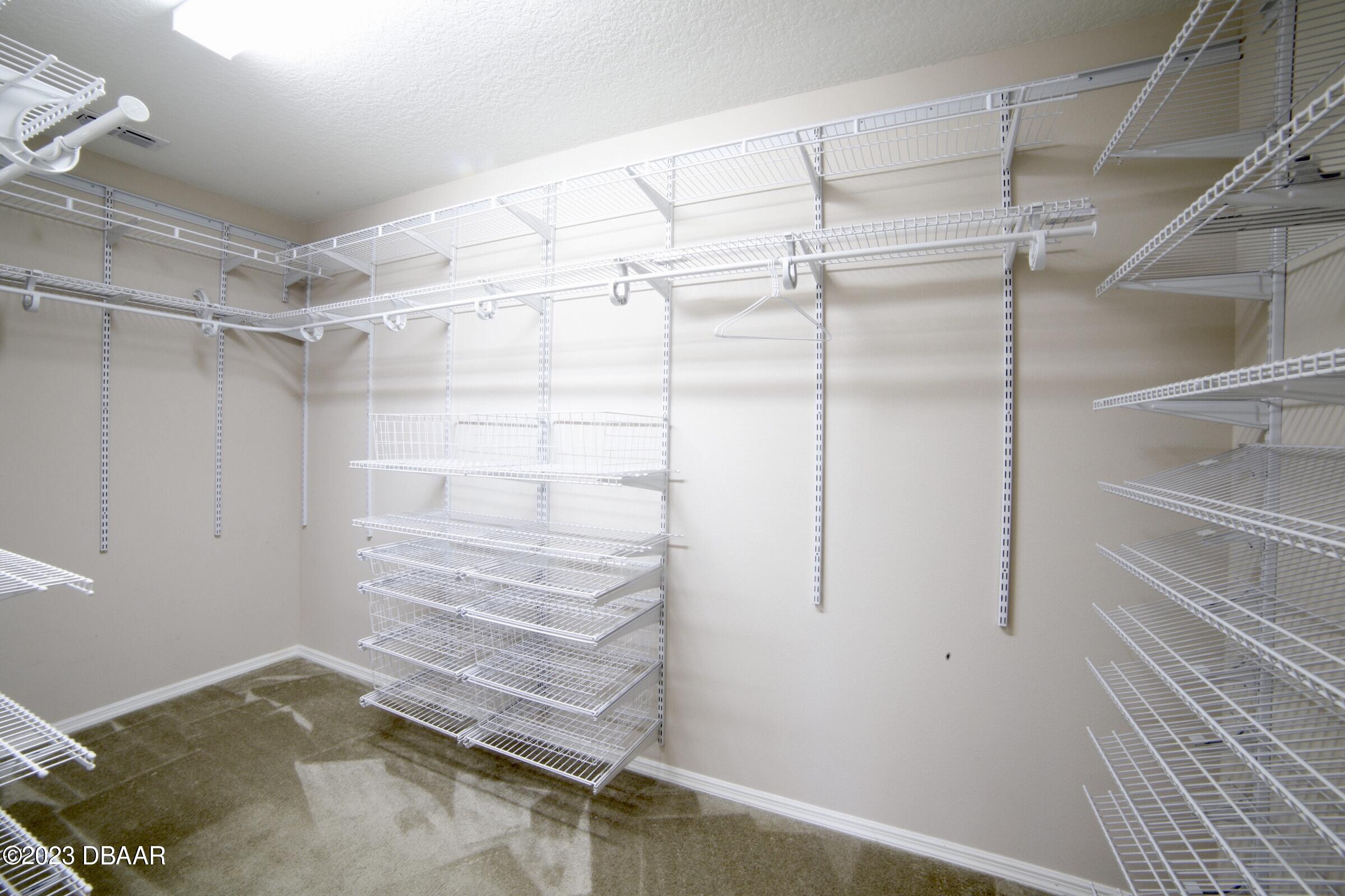 63 Levee Lane Ormond Beach, FL 32174 - Photo 21 of 41 a view of walk in closet with empty racks
