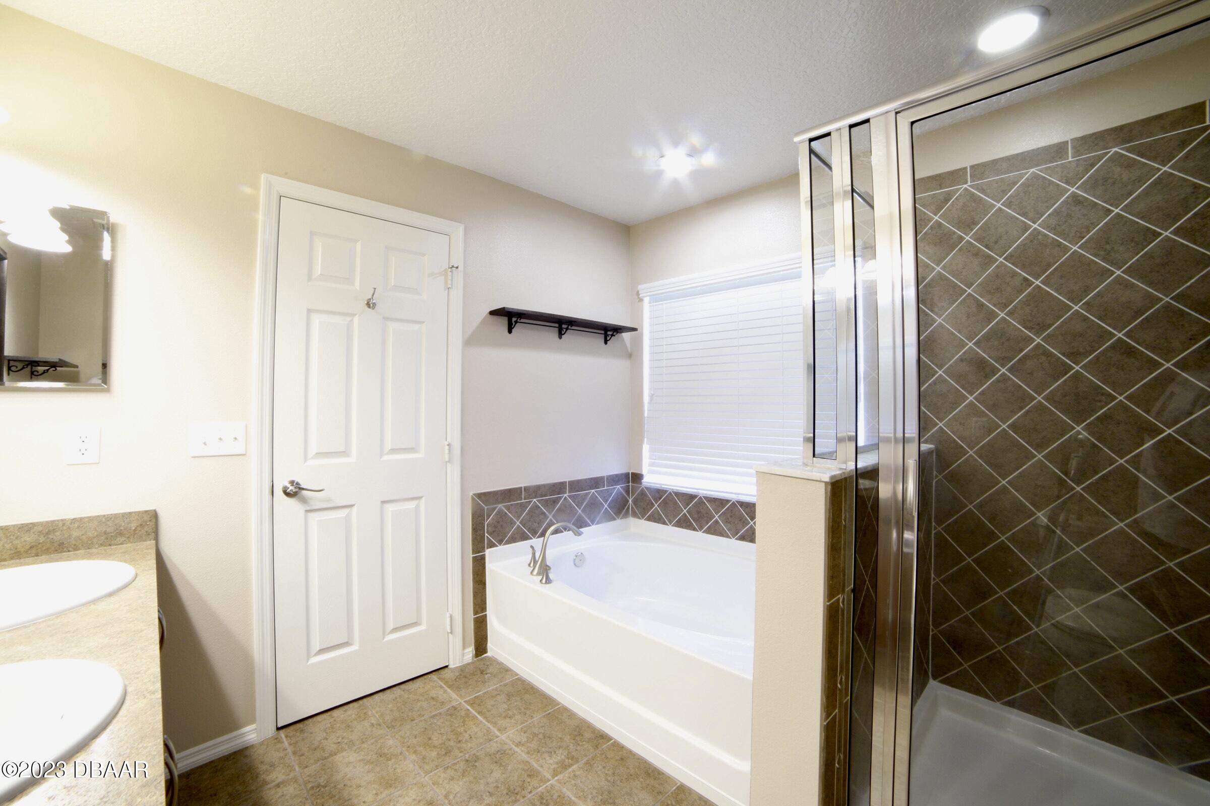 63 Levee Lane Ormond Beach, FL 32174 - Photo 23 of 41 a bathroom with a tub and shower