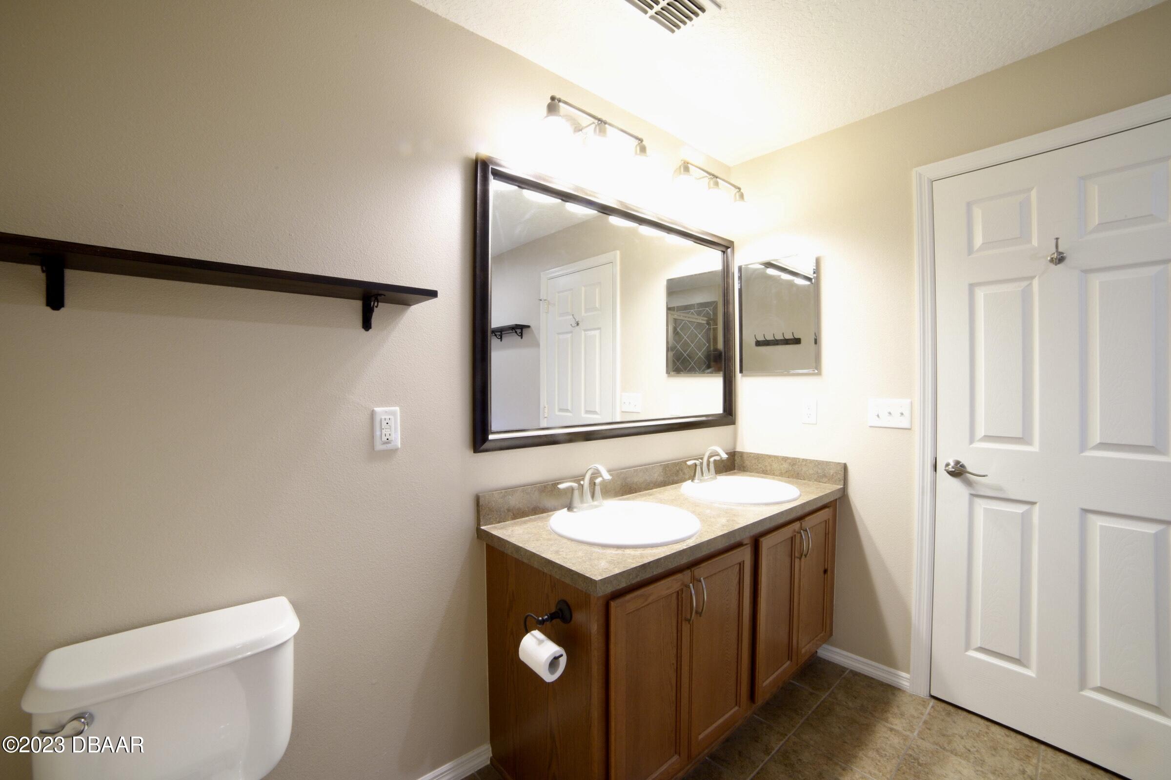 63 Levee Lane Ormond Beach, FL 32174 - Photo 24 of 41 a bathroom with a sink and a mirror