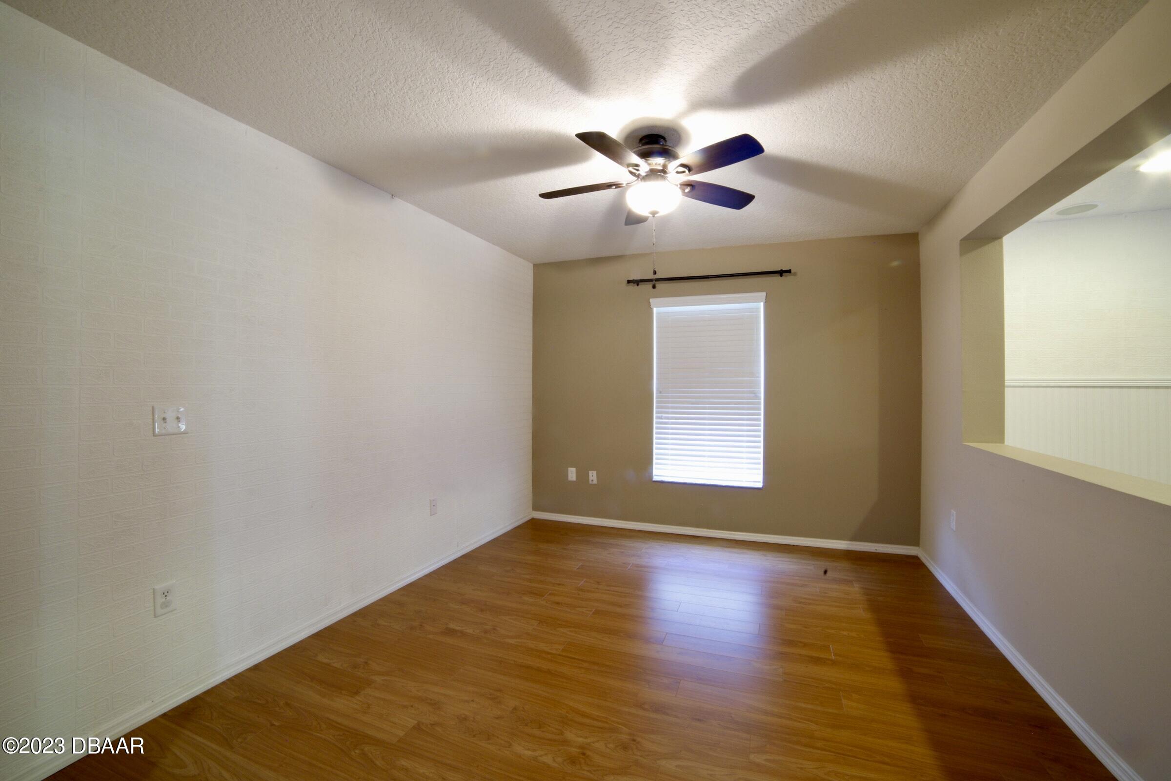 63 Levee Lane Ormond Beach, FL 32174 - Photo 26 of 41 a view of an empty room with window and wooden floor