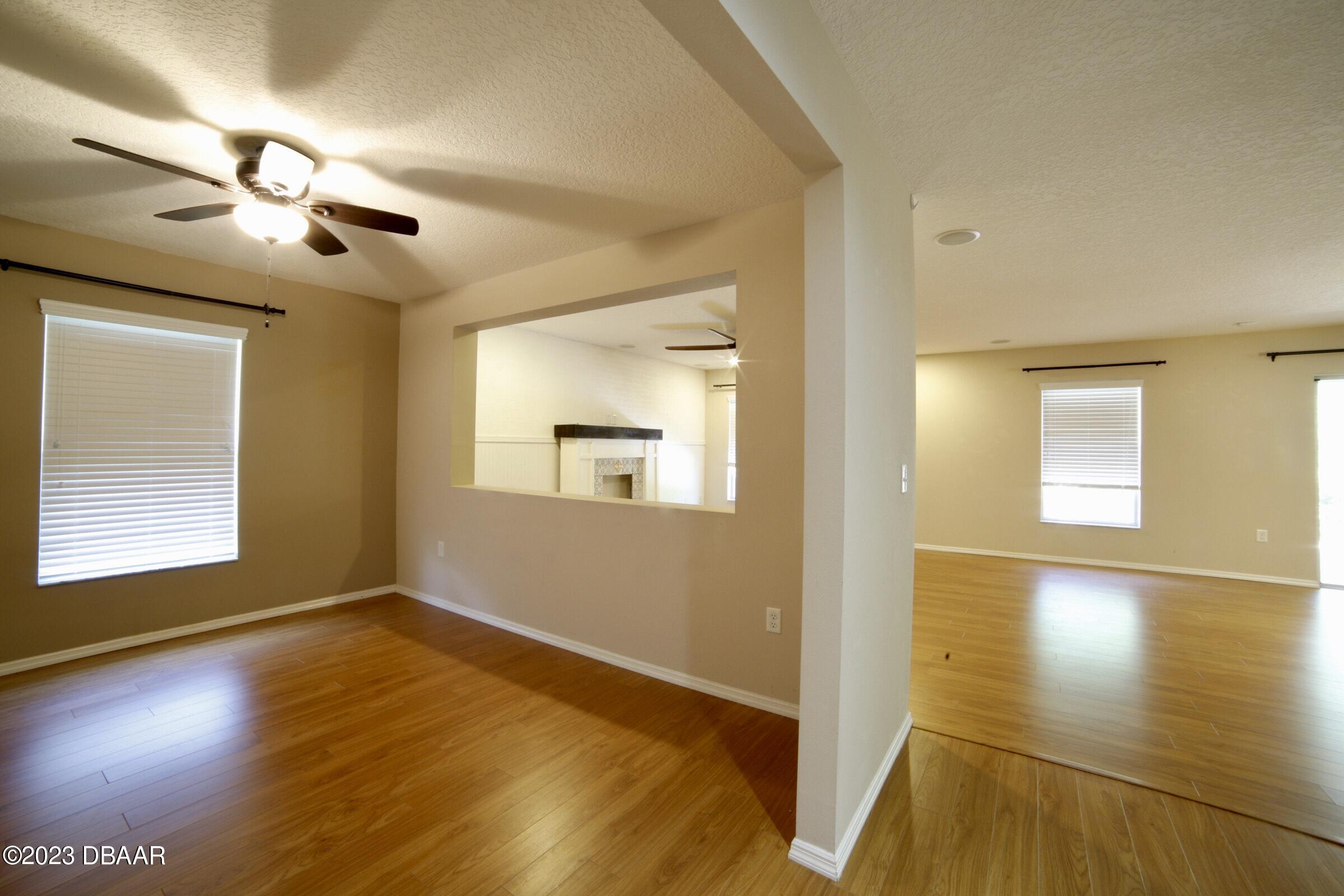 63 Levee Lane Ormond Beach, FL 32174 - Photo 27 of 41 a view of an empty room with wooden floor and a window