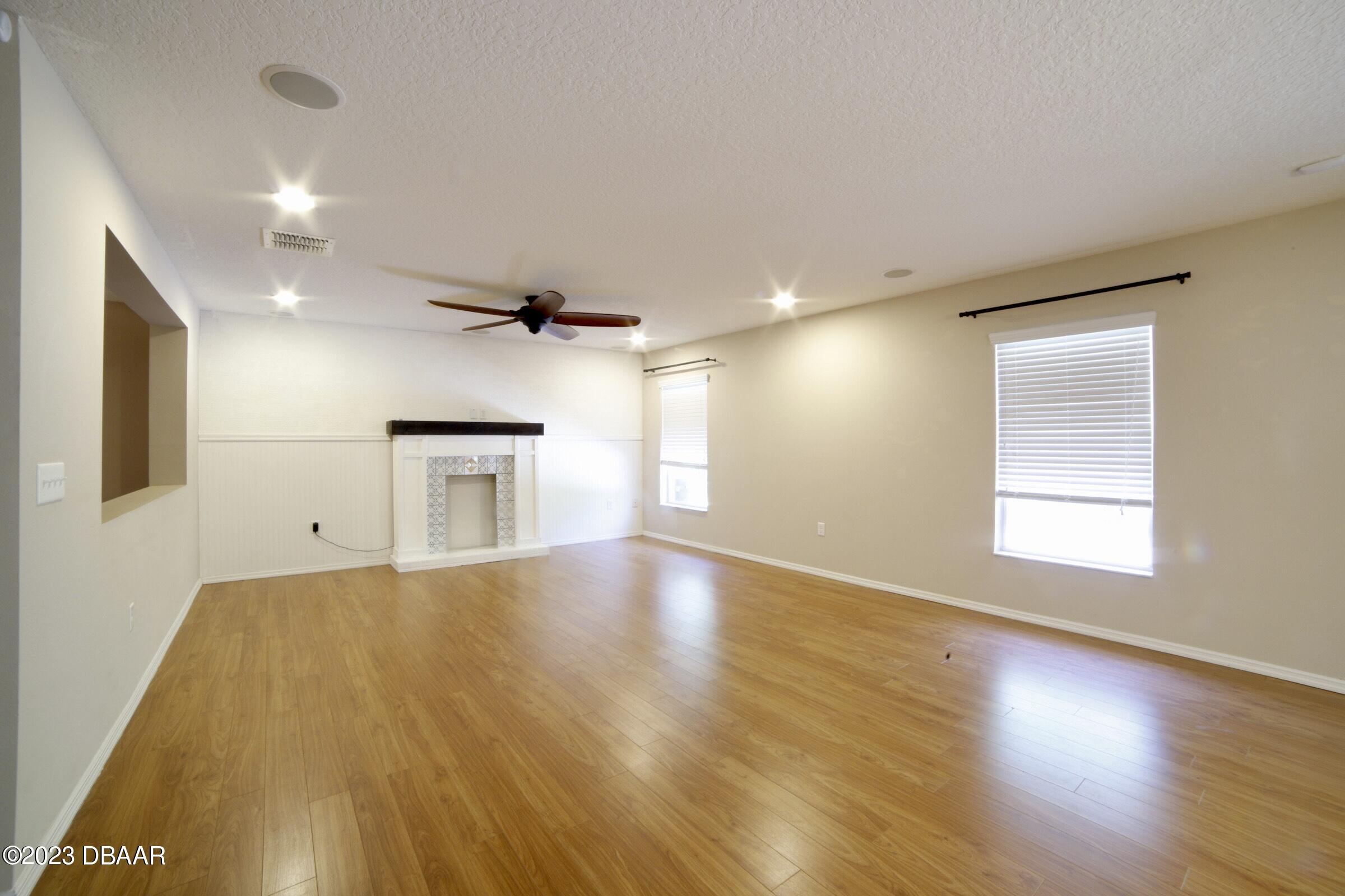 63 Levee Lane Ormond Beach, FL 32174 - Photo 29 of 41 a view of an empty room with a window and wooden floor