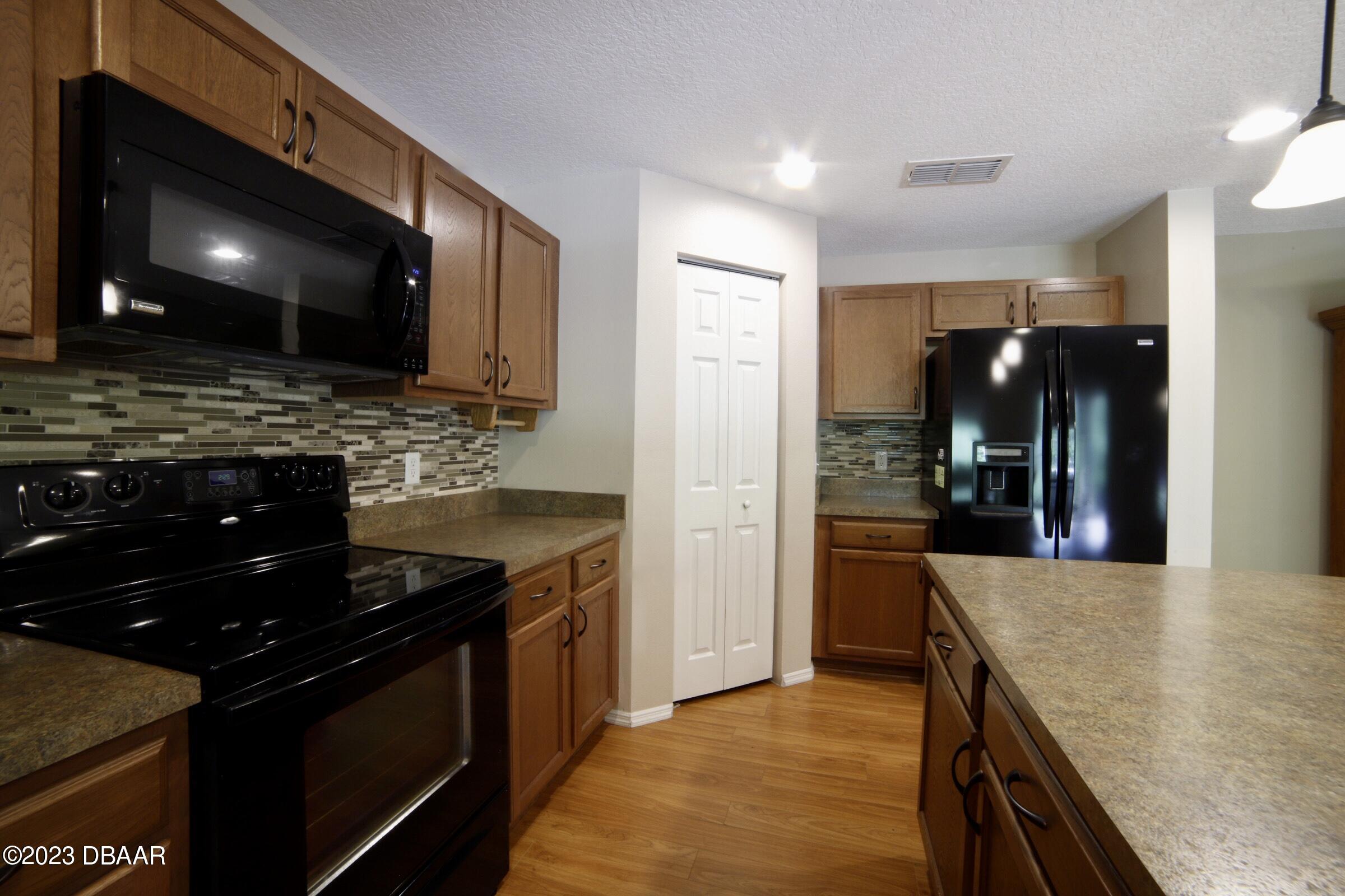 63 Levee Lane Ormond Beach, FL 32174 - Photo 37 of 41 a kitchen with stainless steel appliances granite countertop a sink and a stove