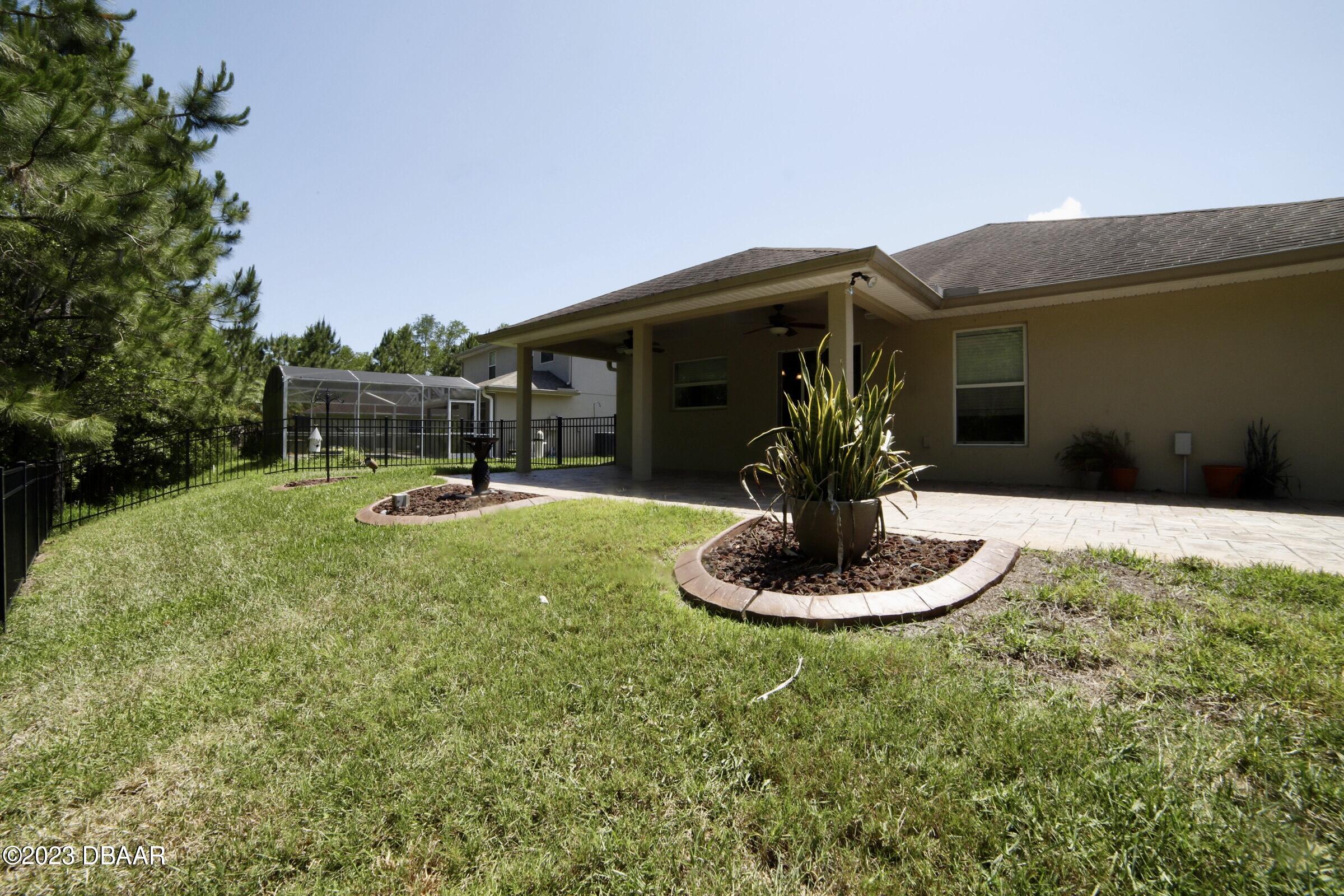 63 Levee Lane Ormond Beach, FL 32174 - Photo 41 of 41 a view of a chair and table in backyard