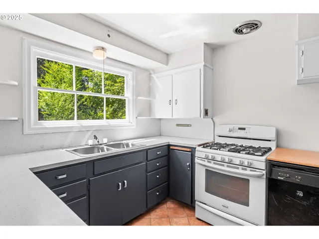 a kitchen with a sink stove and cabinets