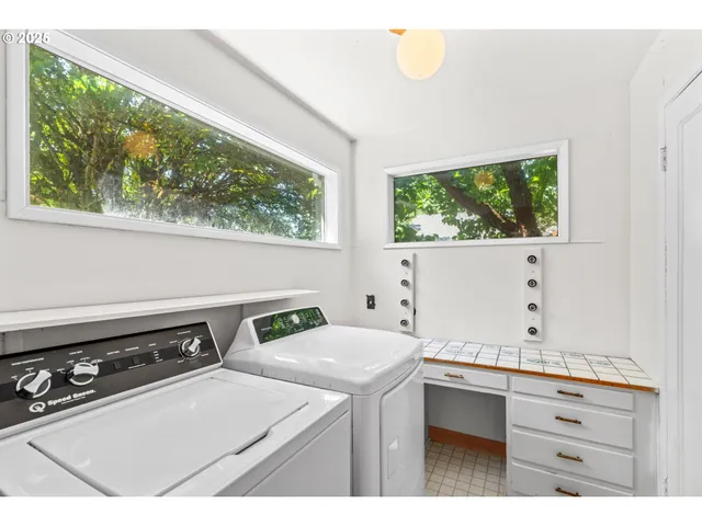 a utility room with sink dryer and washer