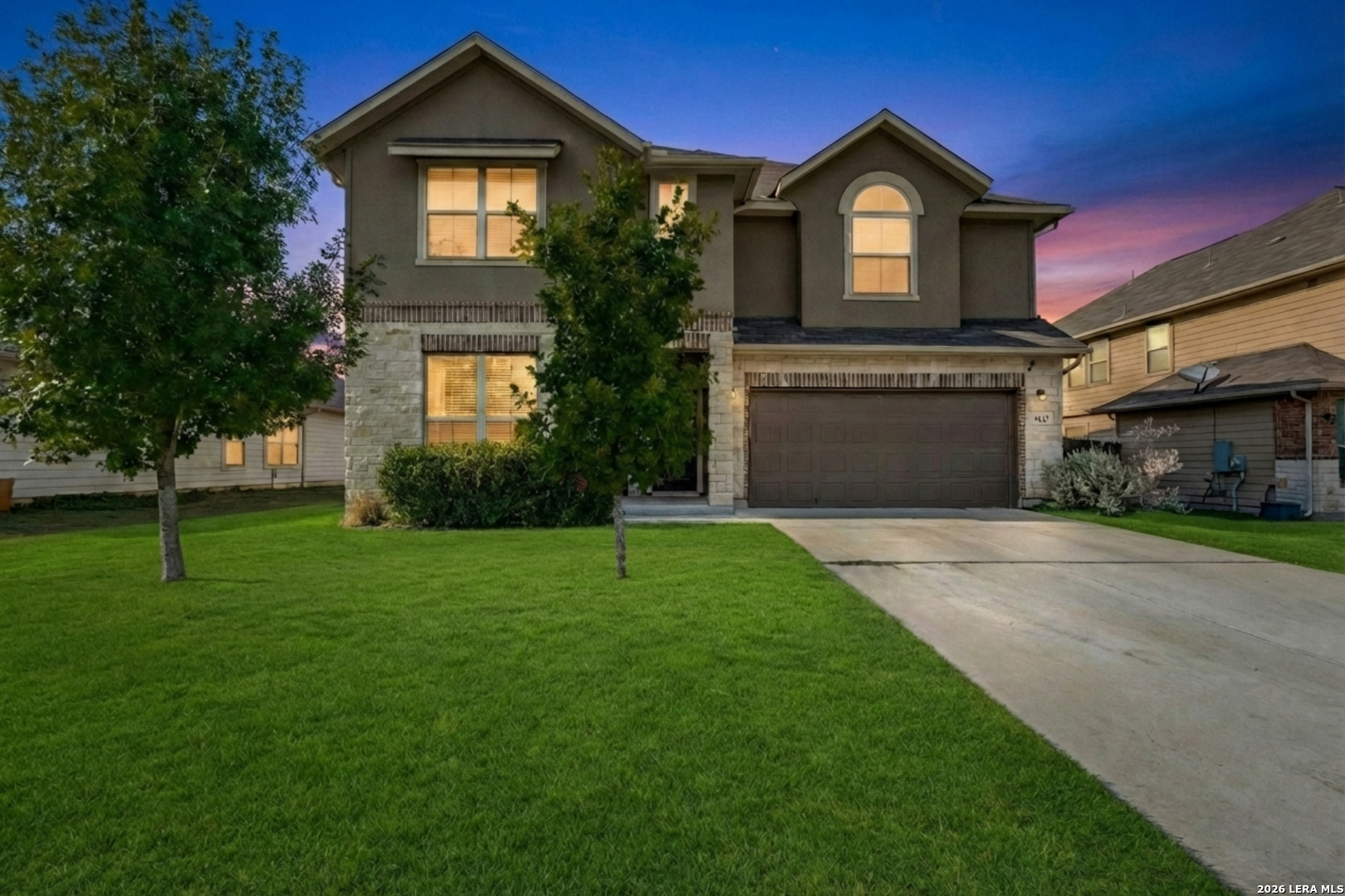a front view of a house with a yard