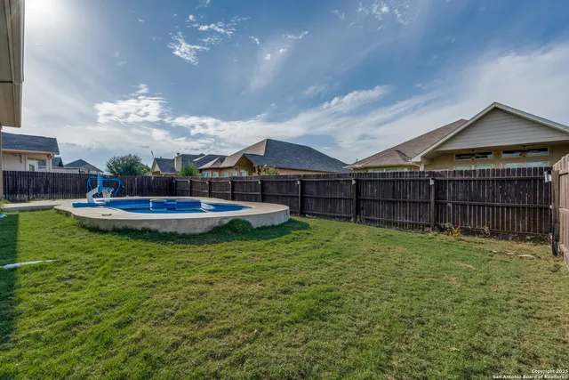 a swimming pool with wooden fence