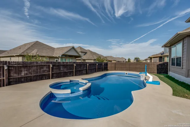 a view of a swimming pool with a lounge chair