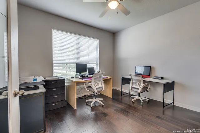a view of a workspace with furniture and a window