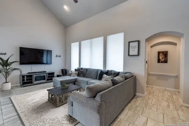 a living room with furniture and a flat screen tv