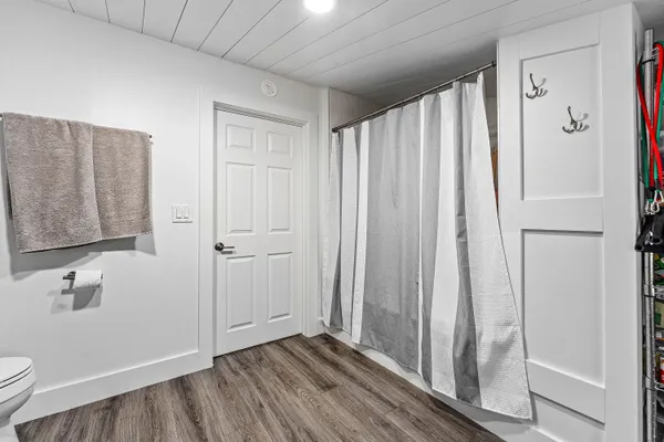 a bedroom with a bed and wooden floor