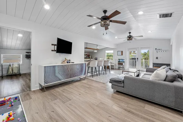 a living room with furniture and wooden floor
