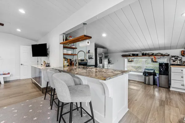 a living room with furniture a wooden floor and chandelier