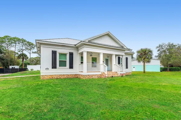 a view of a porch with furniture and a yard