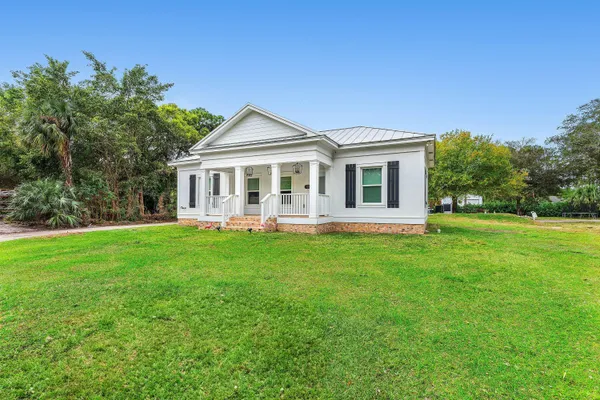 a view of a dining room with furniture wooden floor and chandelier