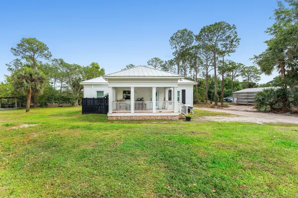 a view of a yard with large trees