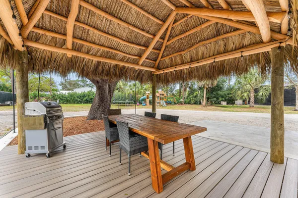 an aerial view of residential houses with outdoor space and trees all around