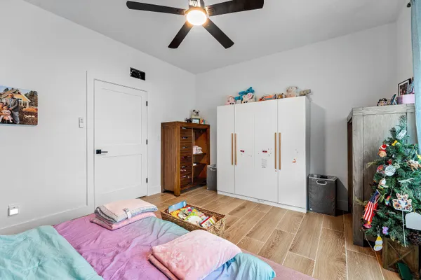 a bedroom with bed and a chandelier