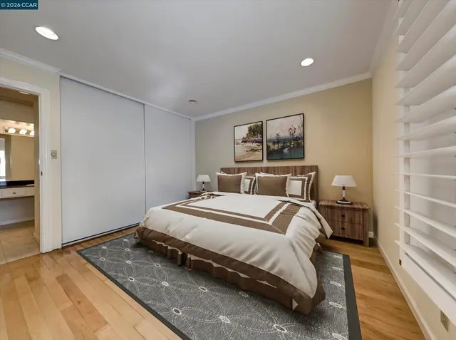 a bedroom with a bed and a painting on the wall