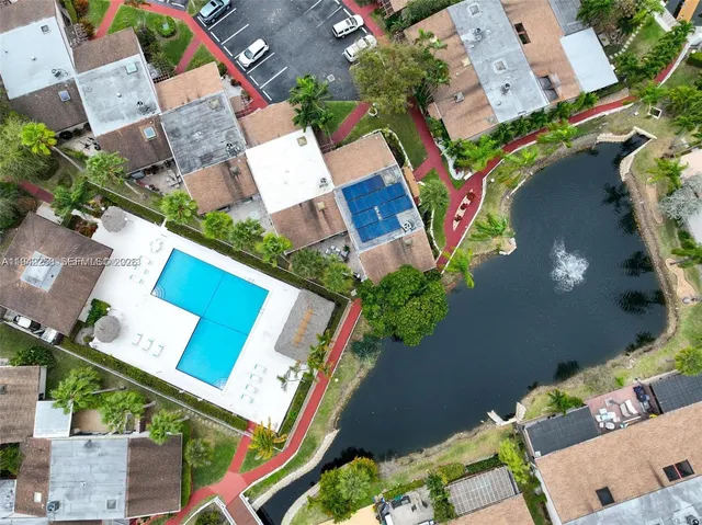 an aerial view of a house with a yard and outdoor seating