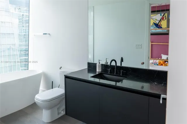 a picture of a bathroom with a sink and a window