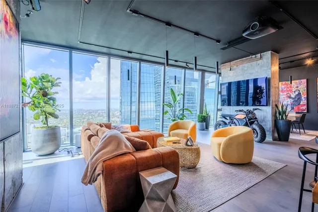 a living room with furniture and a potted plant