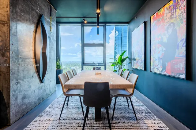 a living room with patio furniture and a floor to ceiling window