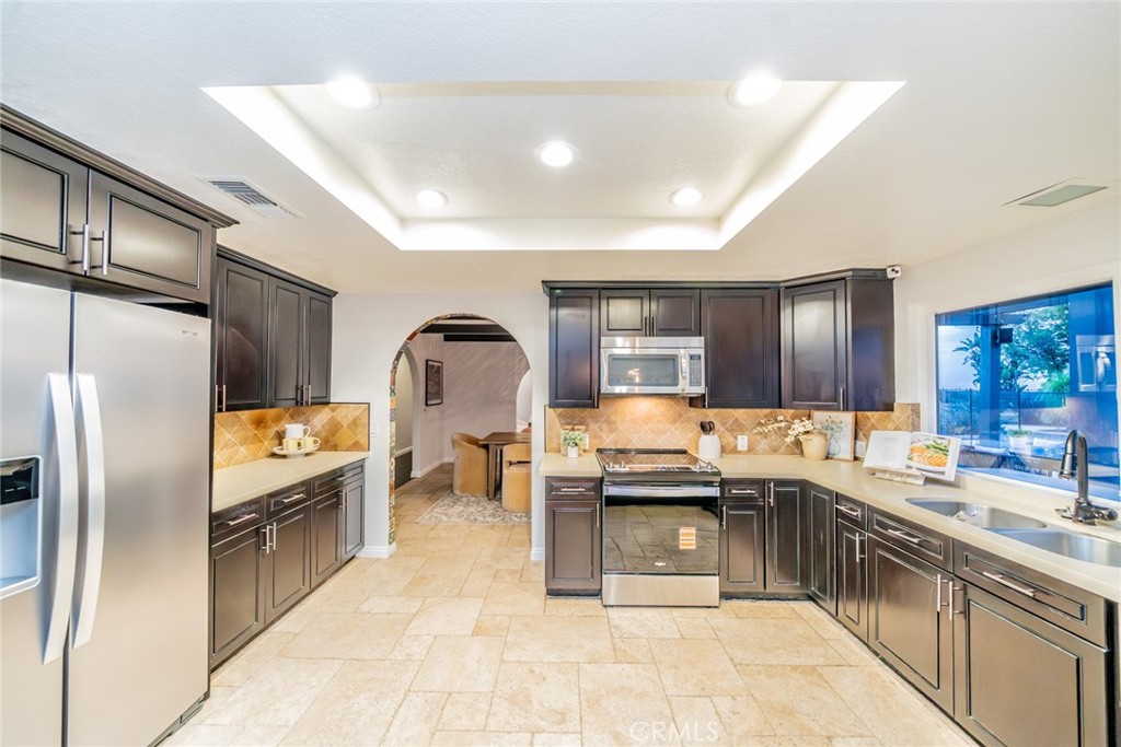 5300 Vía San Jacinto Riverside, CA 92506 - Photo 16 of 59 a kitchen with granite countertop a sink counter top space appliances and cabinets