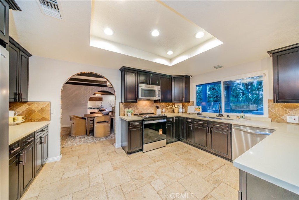 5300 Vía San Jacinto Riverside, CA 92506 - Photo 17 of 59 a kitchen with stainless steel appliances kitchen island granite countertop a sink stove and refrigerator