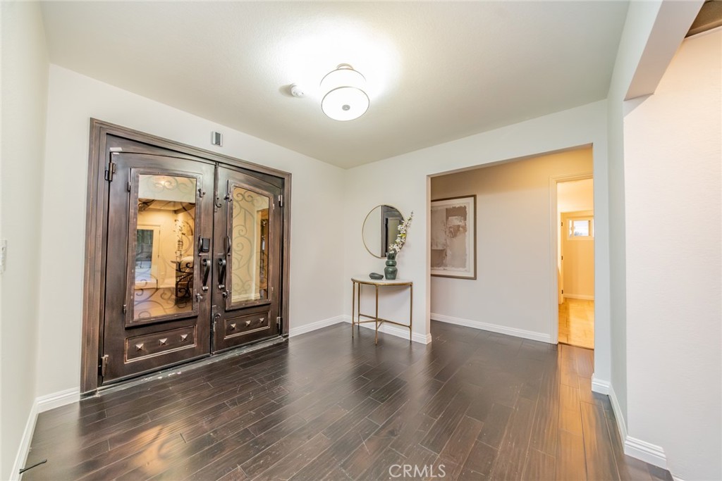 5300 Vía San Jacinto Riverside, CA 92506 - Photo 27 of 59 a view of a hallway with wooden floor and a bathroom