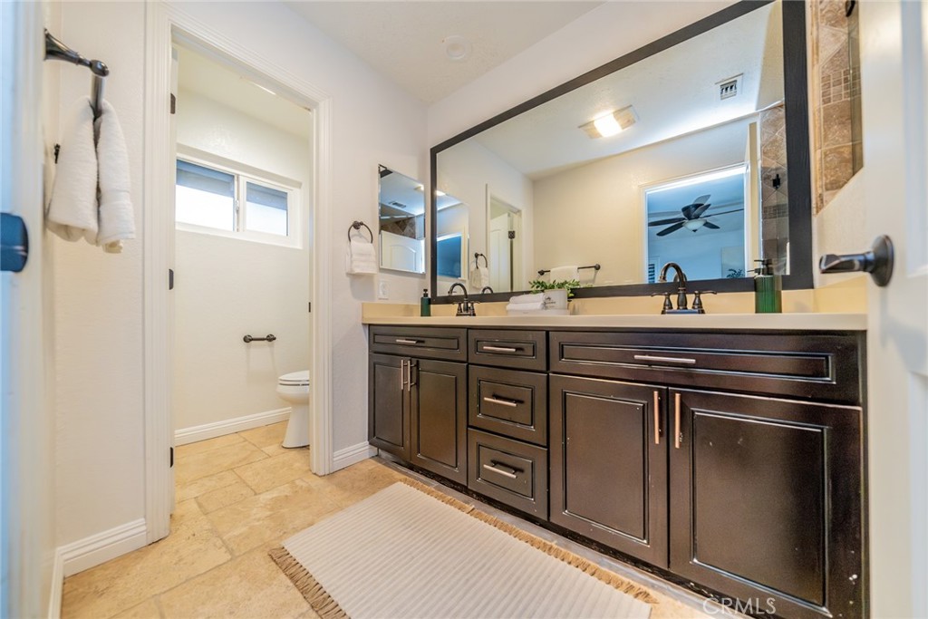 5300 Vía San Jacinto Riverside, CA 92506 - Photo 32 of 59 a spacious bathroom with a granite countertop sink a mirror and a bathtub