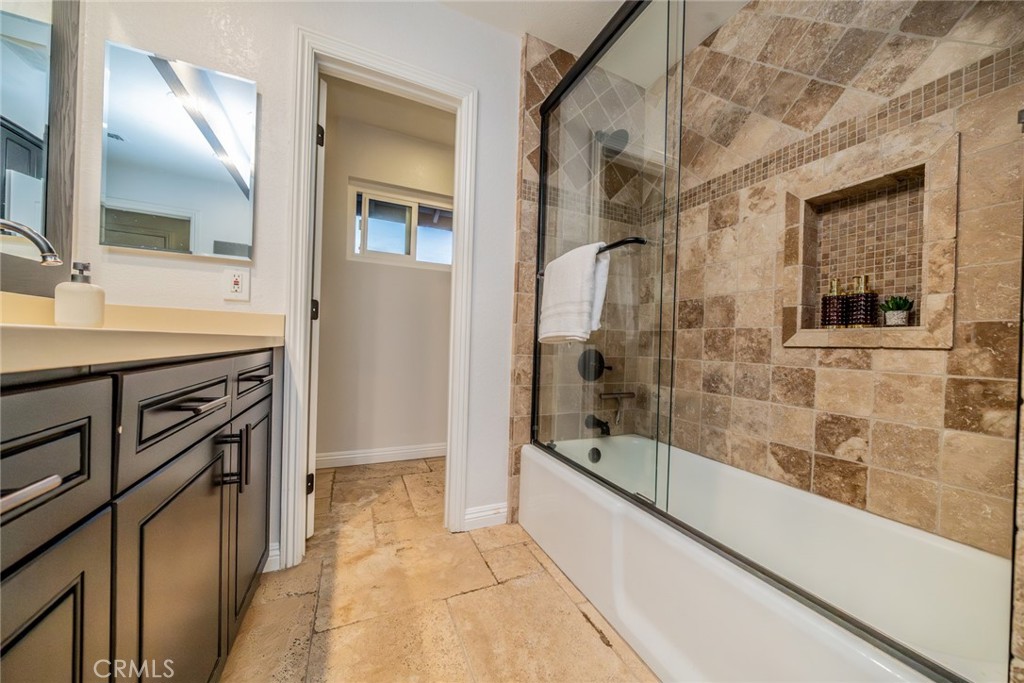 5300 Vía San Jacinto Riverside, CA 92506 - Photo 39 of 59 a bathroom with a granite countertop sink a mirror and a shower